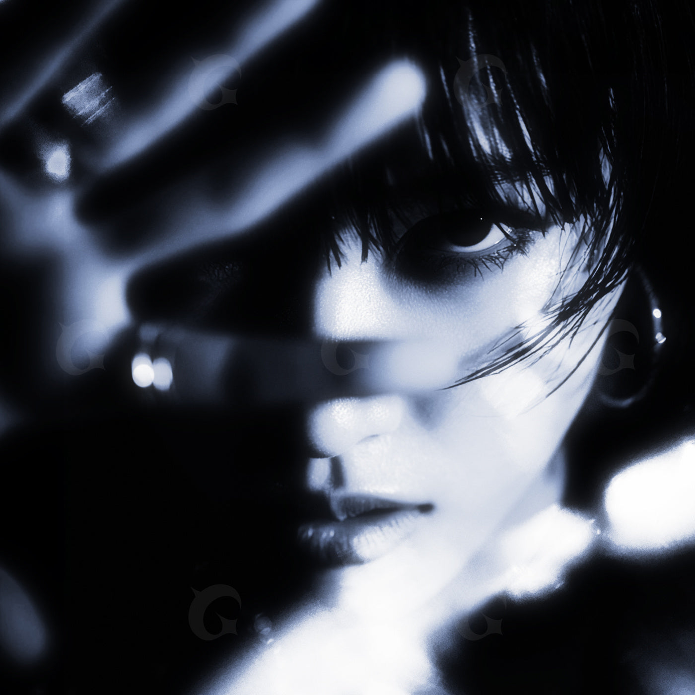 Shadowed gaze between fingers
